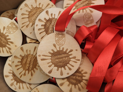 Personalised wooden medals with or without ribbon. Custom wooden medals that can include any wording and logo.