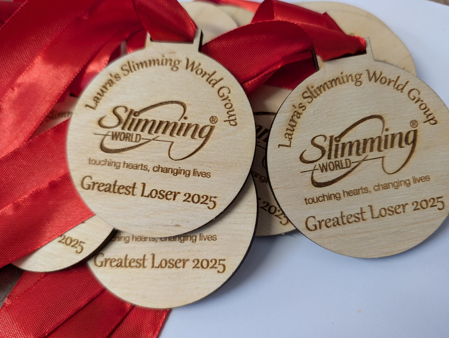 Personalised wooden medals with or without ribbon. Custom wooden medals that can include any wording and logo.