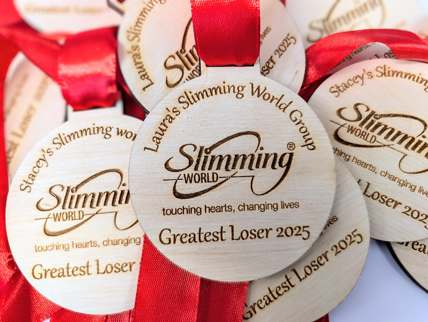 Personalised wooden medals with or without ribbon. Custom wooden medals that can include any wording and logo.