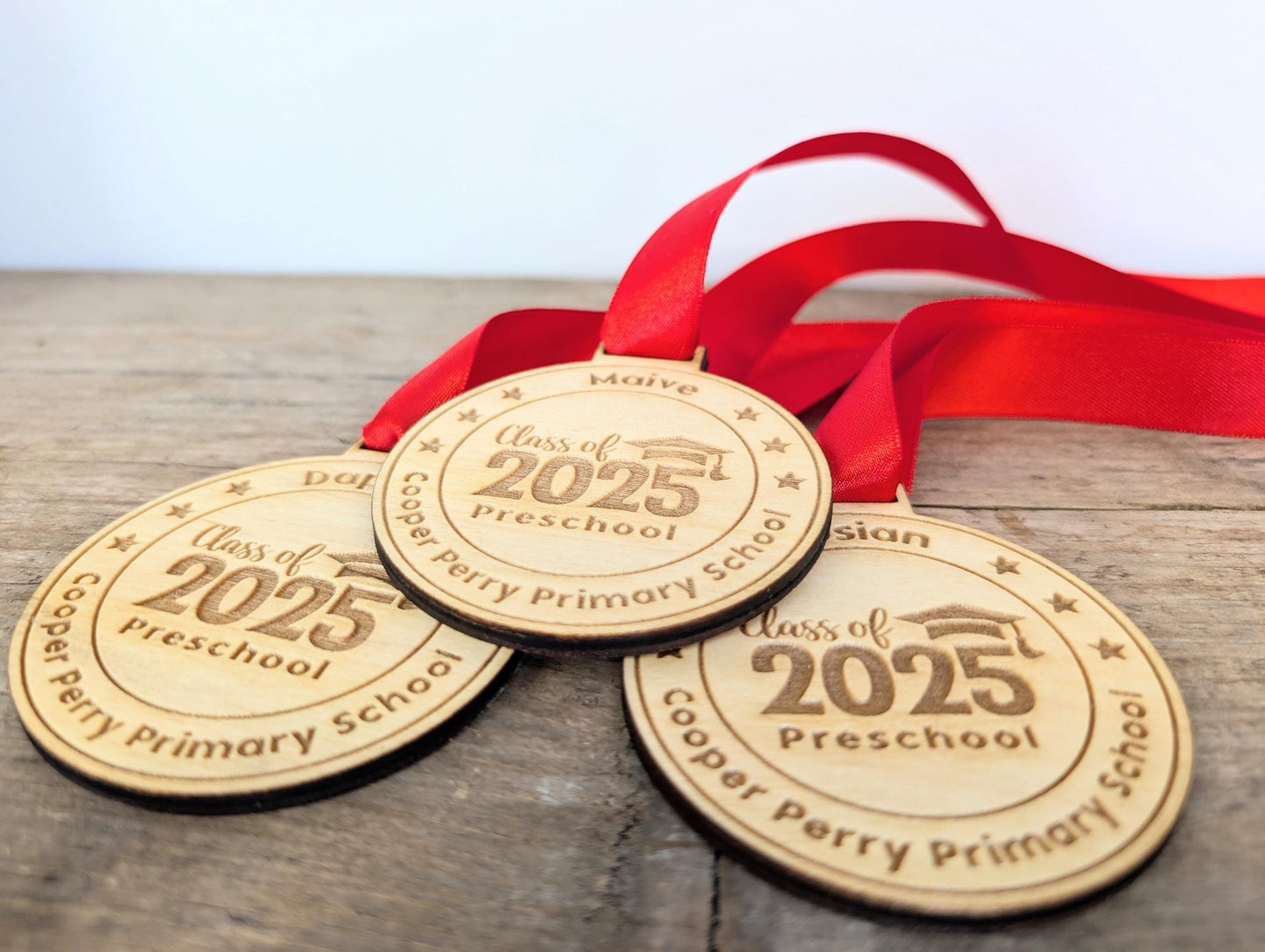 Personalised preschool graduation wooden medals. Wooden custom nursery graduation medals that can include any wording and name.