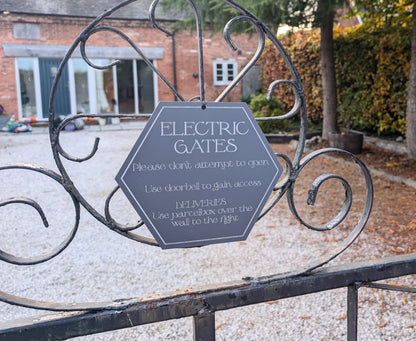 Electric gates, please don't attempt to open wooden sign. Sign for delivery drivers and post.